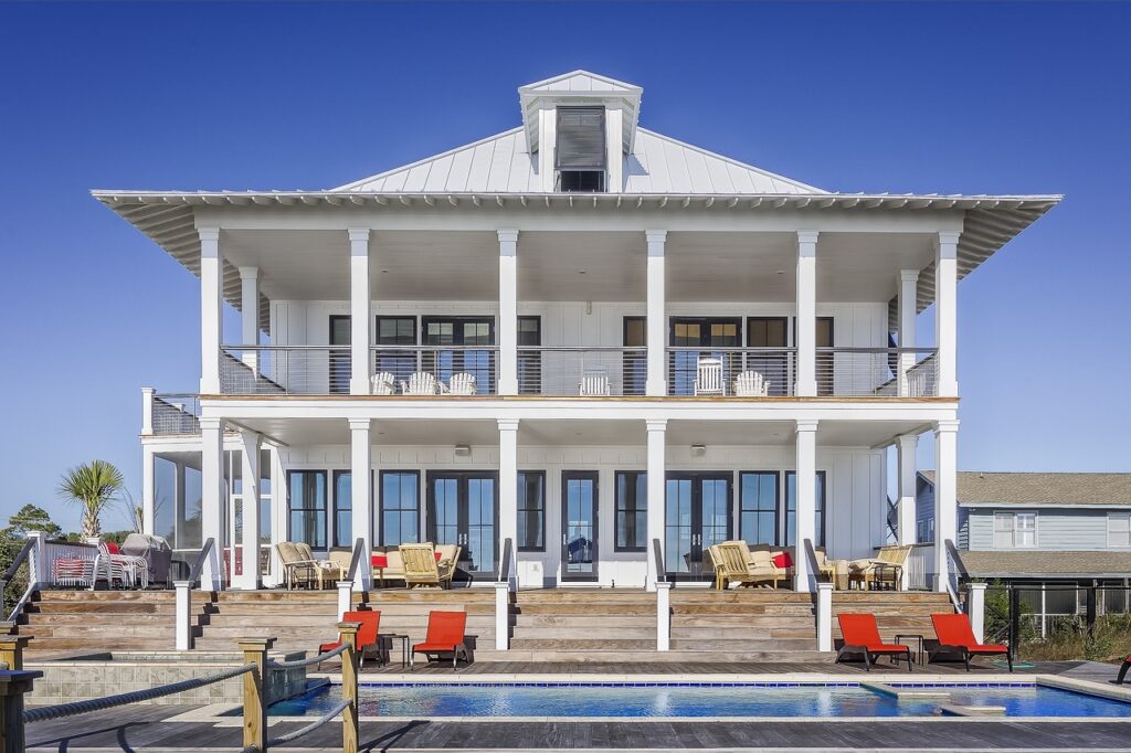 Image of large white house with pool in front to depict home that would be applicable for the vacant residential land tax